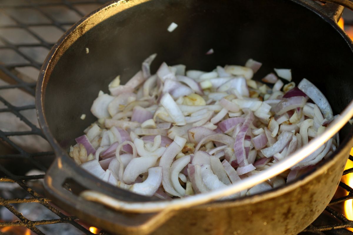 Browning onions and garlic in the potjie pot